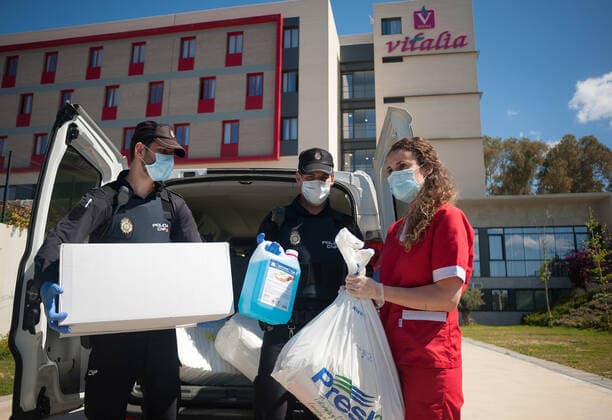 April 22, 2020, Malaga, Spain: Members of Spanish National Police are seen unloading health material made by volunteers of an altruistic group called Malaga helps hospitals outside the residence for the elderly, amid the coronavirus outbreak disease COVID-19. The Spanish National Police in Malaga, under the coordination of citizen participation area, contribute with the non-profit group of 58 people Malaga helps hospitals that sew sanitary material, as protective face masks or white coats made with cotton destined to hospitals and healthcare. Malaga Spain - ZUMAs197 20200422_zaa_s197_183 Copyright: xJesusxMeridax