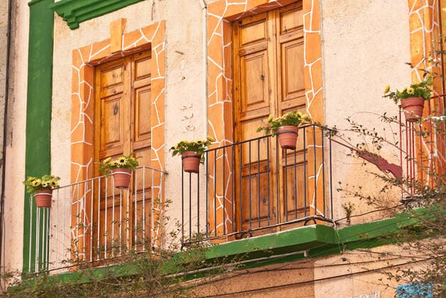 Colonial Mexico Style Picturesque balconies, flower pots and wooden doors in colonial Mexico  Copyright: xWoodkernx 720520