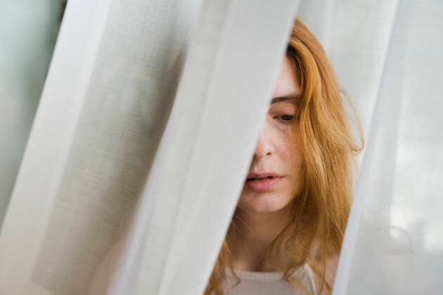 Portrait of sad young woman in a curtain model released Symbolfoto property released AFVF05956