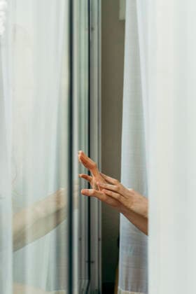 Hand of a woman touching windowpane model released Symbolfoto property released AFVF05957
