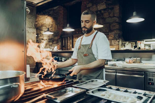 Chef preparing food in restaurant kitchen model released Symbolfoto property released MTBF00368