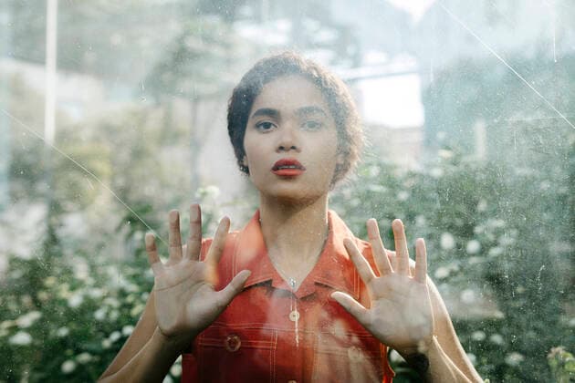 Portrait of young woman behind glass pane model released Symbolfoto TCEF00384