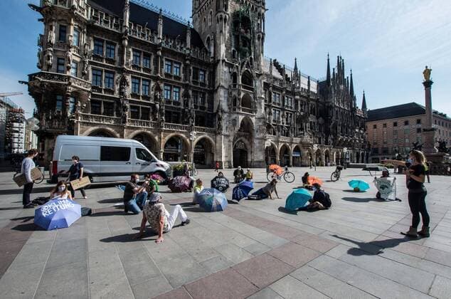 April 24, 2020, Munich, Bavaria, Germany: Members of Extinction Rebellion held one of the early climate protests in the Coronavirus crisis era. Under strict regulations and monitoring by the police for number of participants and distancing, approximately 20 from Extinction Rebellion demonstrated for the climate at Munich s Marienplatz in Germany demanding a Rettungsschirm fuer den Rettungsschirm , roughly translating to a rescue chute for the rescue chute for the economy and markets during the Coronavirus crisis. Munich Germany - ZUMAb160 20200424_zbp_b160_047 Copyright: xSachellexBabbarx