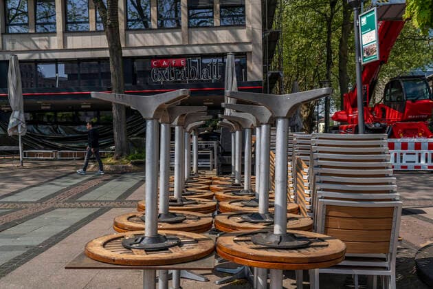 Stacked chairs and tables from various catering establishments, on Kennedyplatz, closed cafes, pubs, restaurants, effects of the corona crisis in Essen, Germany