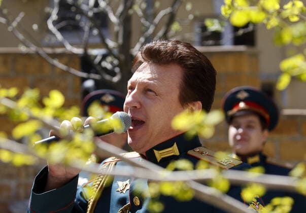 ROSTOV-ON-DON, RUSSIA - APRIL 25, 2020: Singers of the Song and Dance Ensemble of the Russian Army Southern Military District perform outside a block of flats to cheer up people who have to stay at home due to lockdown measures amid the pandemic of the novel coronavirus disease (COVID-19). The open-air concert is part of a series of concerts, which the military musicians plan to perform in various residential areas of the city ahead of the forthcoming 75th anniversary of Soviet Victory in the Great Patriotic War (part of WWII). Rostov-on-Don has been on lockdown since 31 March 2020. Valery Matytsin TASS  TS0D70B9