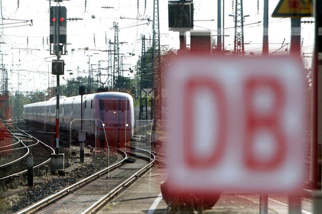 DB Deutsche n Bahn ICE arriving behind a window with company logo at Karlsruhe main station, Baden Württemberg, Germany