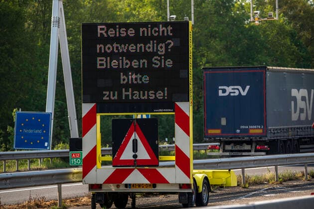 German Dutch border at Emmerich Elten, highway A3, signal board asks travelers to make only necessary trips to the Netherlands, effects of the corona crisis in Germany,