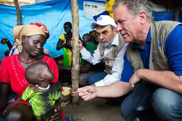 May 23 2017, Ganyiel South Sudan: (Right to left) The Executive Director of the United Nations World Food Programme (WFP), DAVID BEASLEY, and the Director-General of the Food and Agriculture Organization of the United Nations, JOSE GRAZIANO DA SILVA, greet a child with her mother in a nutrition centre run by the International Rescue Committee in Ganyiel, Unity region, South Sudan. The visit is part of the two-day joint mission of WFP and WFP directors in South Sudan to assess the humanitarian situation in the country. Ganyiel, in Panyijiar county is fully controlled by the opposition forces since the civil war broke out in South Sudan in December 2013. Thousands of people are currently displaced, mostly due to the conflict and the hunger in Unity region. While Leer and Mayendit, both also in Unity state, have been recently declared in fam - ZUMAz03_ 20170523_int_z03_992 Copyright: xAlbertxGonzalezxFarran FAOx