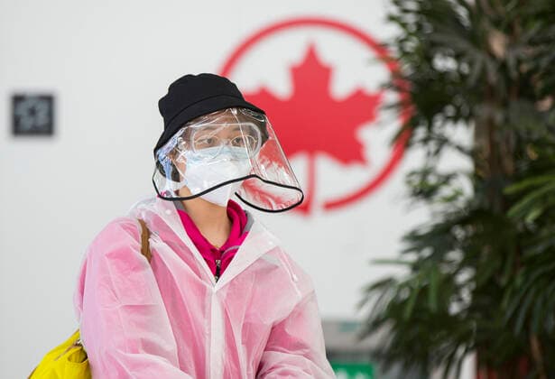 (200427) -- TORONTO, April 27, 2020 -- A traveller wearing protective gear arrives at the Air Canada check-in counters of Pearson International Airport in Toronto, Canada, April 27, 2020. Air Canada suspended all scheduled flights to the United States for four weeks starting on Monday. As of Monday afternoon, there were 48,230 confirmed COVID-19 cases in Canada and 2,701 deaths. (Photo by Xinhua) CANADA-TORONTO-COVID-19-AIR CANADA-FLIGHTS TO U.S.-SUSPENSION ZouxZheng 