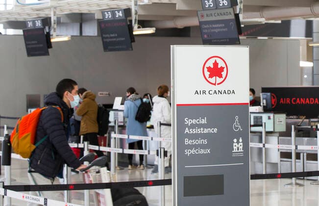 (200427) -- TORONTO, April 27, 2020 -- Travellers check in at the Air Canada counters of Pearson International Airport in Toronto, Canada, April 27, 2020. Air Canada suspended all scheduled flights to the United States for four weeks starting on Monday. As of Monday afternoon, there were 48,230 confirmed COVID-19 cases in Canada and 2,701 deaths. (Photo by Xinhua) CANADA-TORONTO-COVID-19-AIR CANADA-FLIGHTS TO U.S.-SUSPENSION ZouxZheng 