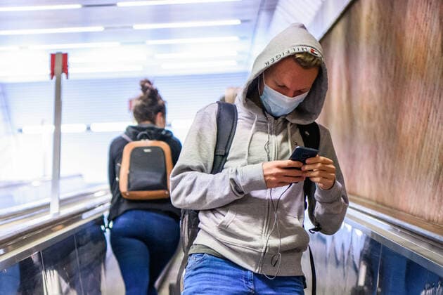 (200428) -- MUNICH, April 28, 2020 (Xinhua) -- A man wearing a face mask looks at his cellphone at a subway station in Munich, Germany, April 27, 2020. In most German states, face masks or an equivalent mouth-and-nose cover have become mandatory on Monday when people travel by bus or train or go shopping. (Photo by Kevin Voigt Xinhua) GERMANY-MUNICH-COVID-19-FACE MASK 