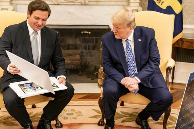 April 28, 2020, Washington, DC, United States of America: U.S. President Donald Trump, right, looks at diagrams and photos during his meeting with Florida Gov. Ron DeSantis in the Oval Office of the White House April 28, 2020 in Washington, DC. Washington United States of America - ZUMAp138 20200428_zaa_p138_013 Copyright: xShealahxCraighead WhitexHousex