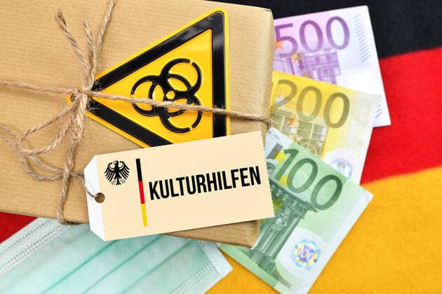 PHOTOMONTAGE, package with biohazard signs on German flag with label and the inscription Kulturhilfen ** NUR FUER REDAKTIONELLE ZWECKE ** EDITORIAL USE ONLY **