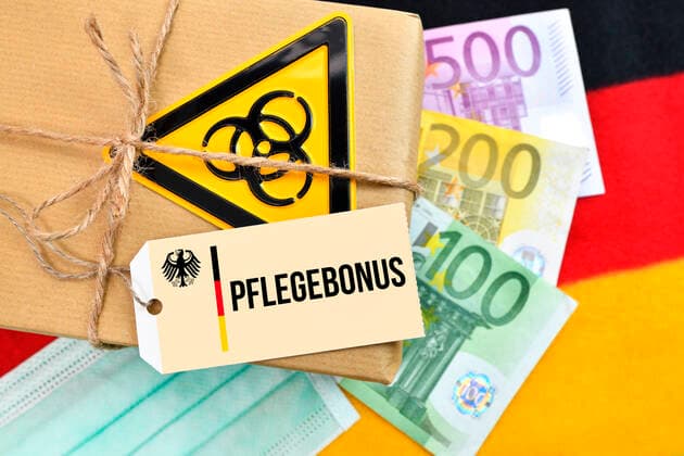 PHOTOMONTAGE, package with biohazard symbol on German flag with label and the inscription Care Bonus ** NUR FUER REDAKTIONELLE ZWECKE ** EDITORIAL USE ONLY **