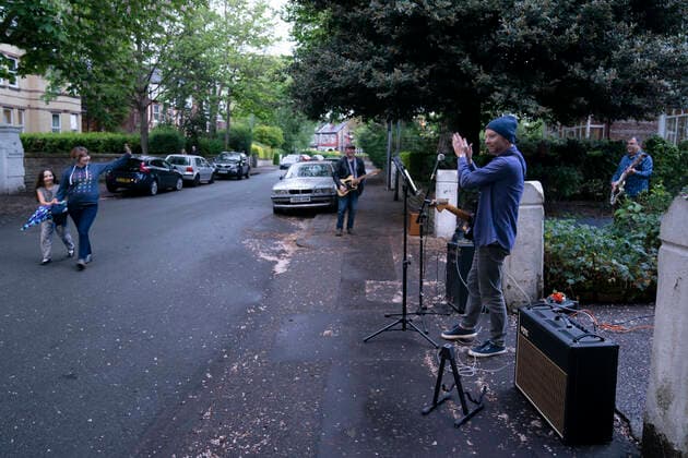 (200501) -- MANCHESTER, May 1, 2020 (Xinhua) -- Residents of the Wood Road in Chorlton play instruments in a street concert as part of the weekly Clap for Our Carers in Manchester, Britain, on April 30, 2020. (Photo by Jon Super Xinhua) BRITAIN-MANCHESTER-COVID-19-STREET CONCERT 