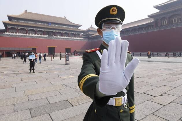Scenes from Beijing A police officer wearing a face mask and goggles works at the Palace Museum in Beijing on May 1, 2020. The museum reopened the same day, limiting the number of visitors to 5,000 per day, following its coronavirus-caused closure. 