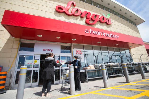 (200504) -- MISSISSAUGA (CANADA), May 4, 2020 -- A staff member (R) hands a face mask to a customer at the entrance of a Longo s in Mississauga, Ontario, Canada, on May 4, 2020. Some provinces in Canada on Monday started easing some of their COVID-19 restrictions following a weekend over which thousands more cases were identified and hundreds more deaths reported. As of Monday afternoon, Canada recorded 60,650 COVID-19 cases, including 3,842 deaths, after the country had implemented lockdown measures against the COVID-19 pandemic for almost two months, according to a CTV News tally. Global COVID-19 deaths surpassed 250,000 on Monday afternoon, reaching 250,134 as of 4:40 p.m. (2040 GMT), according to the Center for Systems Science and Engineering at Johns Hopkins University. (Photo by Xinhua) CANADA-ONTARIO-MISSISSAUGA-COVID-19-MEASURES