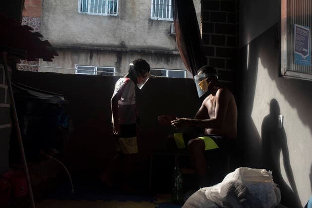 May 6, 2020, Rio De Janeiro, Rio de Janeiro, Brazil: May 08.., 2020, Rio De Janeiro, May 08.., 2020, Rio De Janeiro - Alves 40 years old, lives in the 5 Bocas favela taking care of his 8-year-old son Samuel, he is survivor from the Corona Virus Covid 19, he was infected and stayed in the hospital for 10 days, every day they wear his mask and face shield. protection, so as not to contaminate your son Samuel. Rio De Janeiro Brazil - ZUMAt142 20200506_zap_t142_001 Copyright: xFabioxTeixeirax