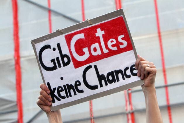 An authorized demonstration against the corona related infection protection law and the associated restrictions on freedom took place in the city center of Cologne, North Rhine-Westphalia, Germany A demonstrator holds up a poster with the words Give Gates no chance