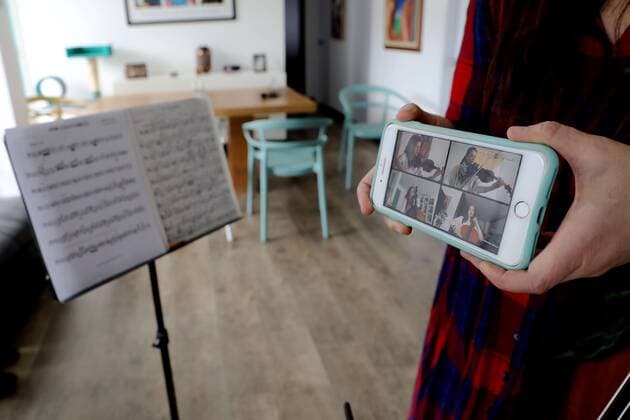 Photograph dated May 9, 2020 in which the bassist of the Bogota Philharmonic Orchestra Monica Suarez is seen while playing her instrument and recorded with her mobile phone in the living room of her apartment in Bogota, Colombia 10 May 2020. In these days of pandemic and confinement, the musicians of the Bogota Philharmonic Orchestra have taken advantage of technology and social networks to express their art and present themselves to an audience that cannot be crowded to see them live and direct. The COVID-19 changes the score to the musicians of the Bogota Philharmonic !ACHTUNG: NUR REDAKTIONELLE NUTZUNG!  Copyright: xCarlosxOrtegax AME8912 20200510-637247324555918169