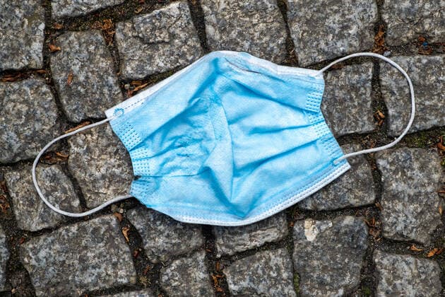 Disused protective mask lies thrown away on the street in Berlin Coronakrise garbage