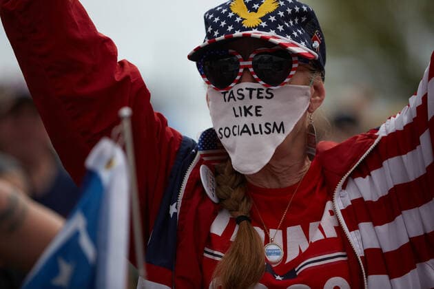 May 16, 2020, Swampscott, Massachusetts, USA: A woman wears a mask with tastes like socialism written on it at a Re-open Massachusetts protest. A protest was held in front of Governor Baker s home. Swampscott USA - ZUMAd211 20200516_zap_d211_019 Copyright: xAllisonxDinnerx
