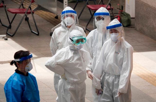 COVID-19 testing station near Itaewon, May 14, 2020 : Medical team members at a makeshift clinic for COVID-19 testing near Itaewon in Seoul, South Korea. One of Seoul s nightlife districts, Itaewon has emerged as a hotbed for coronavirus infections in May but the country saw a marked slowdown in cluster infections linked to Itaewon as of May 19, local media reported.  (126446531)
