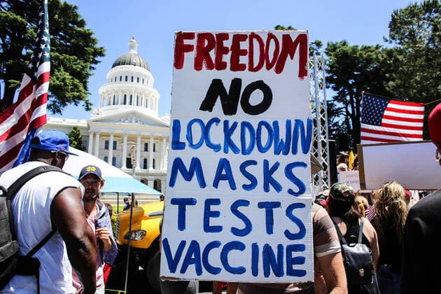 May 23, 2020, Sacramento, California, United States: A protester holds a placard that says Freedom No Lockdown Masks Tests Vaccine during the demonstration..Protesters gathered outside the California State Capitol to protest the California Stay-At-Home Orders and to call for the reopening of the California economy. Sacramento United States - ZUMAs197 20200523_zaa_s197_174 Copyright: xStantonxSharpex