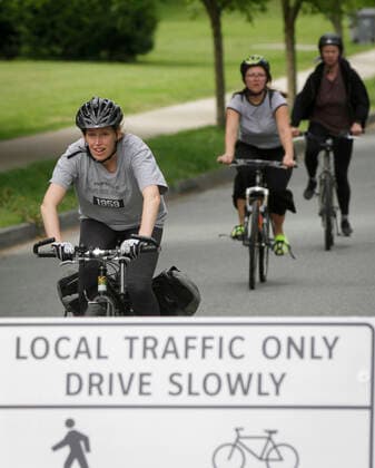 (200525) -- VANCOUVER, May 25, 2020 (Xinhua) -- People cycle on the Slow Street at a road in Vancouver, Canada, May 24, 2020. City of Vancouver unveiled the Slow Streets program allowing people to walk and bike on the roads with limited local traffic in order to provide more space to the people to maintain physical distance. (Photo by Liang Sen Xinhua) CANADA-VANCOUVER-COVID-19-SLOW STREETS 