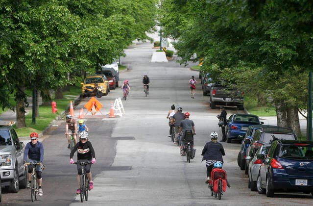 (200525) -- VANCOUVER, May 25, 2020 (Xinhua) -- People cycle and jog on the Slow Street at a road in Vancouver, Canada, May 24, 2020. City of Vancouver unveiled the Slow Streets program allowing people to walk and bike on the roads with limited local traffic in order to provide more space to the people to maintain physical distance. (Photo by Liang Sen Xinhua) CANADA-VANCOUVER-COVID-19-SLOW STREETS 
