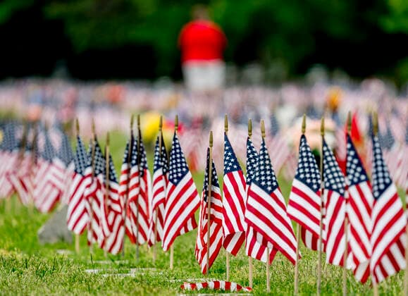 May 25, 2020, Bear, DE, USA: May 25, 2020: A visitor walks among the grave stones and flags while paying respects on Memorial Day. While the Delaware Veterans Memorial Cemetery did not hold their annual Memorial Day remembrance service, many showed up with masks and observing social distancing to pay respects and remember loved ones during the coronavirus pandemic. ESW CSM Bear USA - ZUMAcs17 0047281414st Copyright: xScottxSeriox