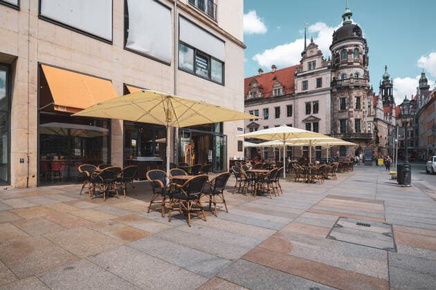 empty tables on the terrace of the Cafes Restaurant Alex opposite the Dresden Castle