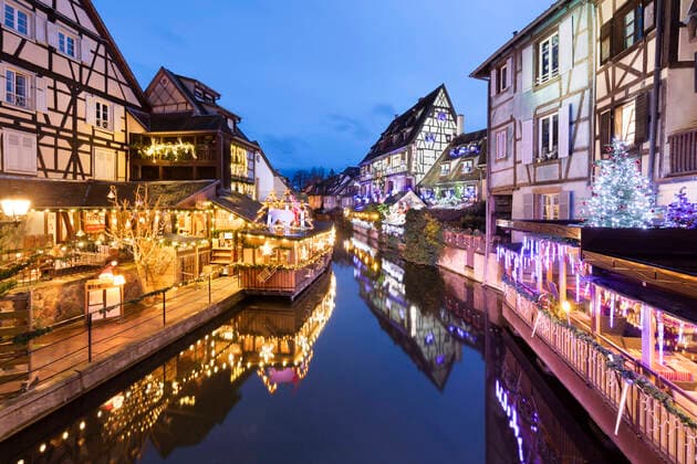 Christmas decorations on old buildings along La Lauch river in the Little Venice area at night, Colmar, Alsace, France, Europe Copyright: StuartxBlack 846-3003 Editorial Use Only