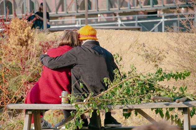 A couple sit and embrace outdoors on a sunny autumn day New York, NY, United States CR_ANMAGM200506-374227-01,EDITORIAL USE ONLY