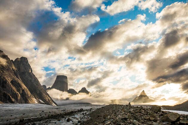 Mt. Loki and Mt. Asgard emerge from the clouds as a storm blows over. Pangnirtung, NU, Canada CR_JDIP200518-319423-01