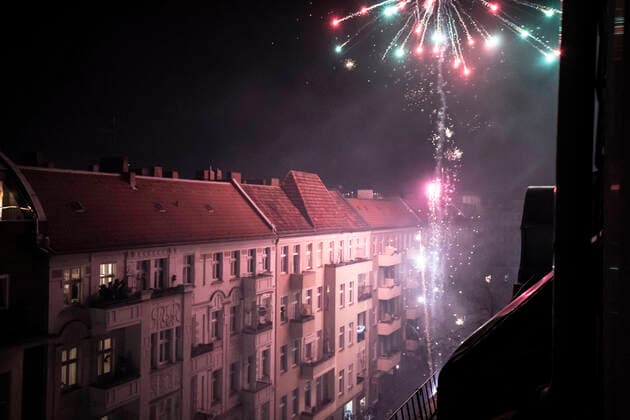 Home fireworks explode from balcony high in Berlin streets new year CR_PIDODS200410A-326461-01