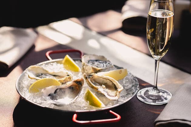 Plate with oysters, lemon and ice and a glass of champagne Rivne, Rivne Oblast, Ukraine CR_VIYA200415-349771-01
