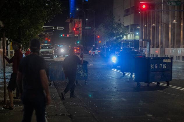 May 31, 2020, USA: June 1, 2020 Protestors in downtown Albuquerque look for cover as Albuquerque police officers in riot gear prepare to clear downtown Albuquerque of protestors after businesses were vandalized and fires were set. USA - ZUMAab1_ 20200531_zaf_ab1_015 Copyright: xAlbuquerquexJournalx
