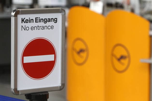 Air traffic has almost come to a complete standstill due to the corona crisis One-way street sign No entrance in front of closed and orphaned Lufthansa check-in counters in deserted Terminal 1 in departure hall A at Frankfurt Airport, Hesse, Germany