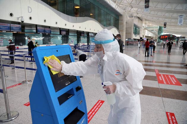 (200601) -- ANKARA, June 1, 2020 -- A worker disinfects a check-in kiosk at Ankara Esenboga Airport in Ankara, Turkey, on June 1, 2020. Turkey s airline companies resumed their domestic operations on Monday with a limited number of flights. (Photo by Xinhua) TURKEY-ANKARA-DOMESTIC FLIGHTS-RESUMPTION MustafaxKaya 