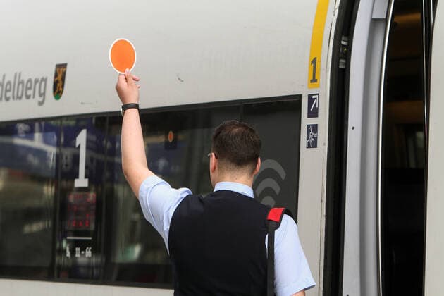 Train attendant of DB Deutsche n Bahn AG handling an ICE Intercity Express at Frankfurt Central Station, Hesse Germany