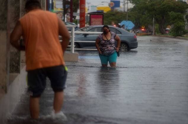 Two people walk trough a flooded avenue in Merida, Yucatan state, Mexico, 02 June 2020. The tropical storm Cristobal will stay a couple of days in the southern area of the bay of Campeche, and will cause a storm of torrential rains on the coasts of the Gulf of Mexico, revealed on Tuesday the National Weather Service (SMN). After evolving into a tropical storm, Cristobal is located 215 kilometers northeast of Coatzacoalcos and 245 kilometers west-southwest of Campeche, in waters of the Gulf of Mexico, the SMN said in its bulletin at 16.15 hours (21.15 GMT). Tropical storm Cristobal will stay two days off the Mexican coast of Campeche !ACHTUNG: NUR REDAKTIONELLE NUTZUNG!  Copyright: xCuauhtémocxMorenox MEX2016 20200603-637267518155290684