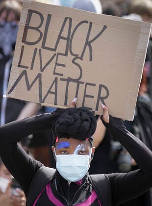 (200606) -- VANCOUVER, June 6, 2020 -- A protestor carries a sign during an anti-racism rally over the death of George Floyd at Jack Poole Plaza in Vancouver, Canada, June 5, 2020. (Photo by Xinhua) CANADA-VANCOUVER-ANTI-RACISM RALLY LiangxSen 