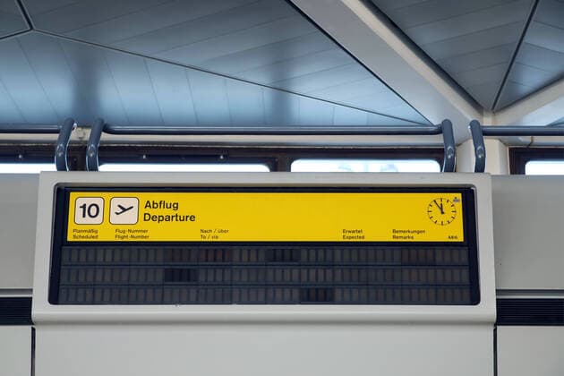 04 06 2020, Berlin Germany Tegel TXL Airport, the check-in counters are empty due to the corona crisis The clock shows 5 to 12