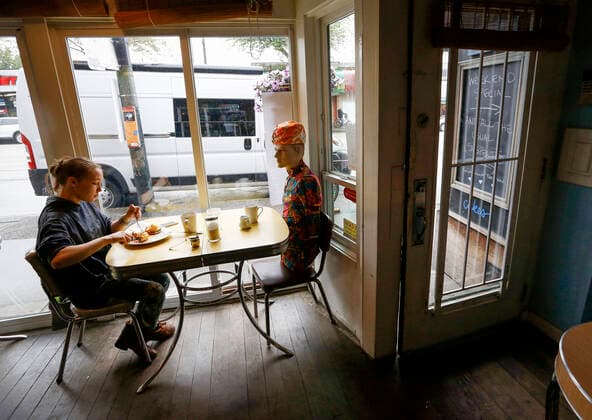(200615) -- VANCOUVER, June 15, 2020 (Xinhua) -- A mannequin is used to block off a seat at Roundel Cafe to give diners enough physical distance in Vancouver, British Columbia, Canada, on June 15, 2020. As restaurants were reopened under health safety protocols in Vancouver, the restaurant Roundel Cafe found its way by using mannequins instead of cordoned-off seats to help diners practice physical distancing. (Photo by Liang Sen Xinhua) CANADA-VANCOUVER-COVID-19-RESTAURANT-PHYSICAL DISTANCE 