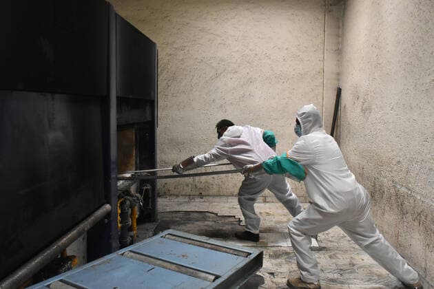 MEXICO CITY, MEXICO - JUNE 15: Workers wear protective gear while they insert the body of a person who died from COVID-19 complications into the oven for cremation at San Isidro Crematorium on June 15, 2020 in Mexico City, Mexico Where: Mexico City, Mexico When: 15 Jun 2020 Credit: Eyepix Cover Images **EDITORIAL USE ONLY** Copyright: xCarlosxTischlerx 40569562 EDITORIAL USE ONLY. NOT FOR USE BY NEWSPAPERS BASED IN THE UK.