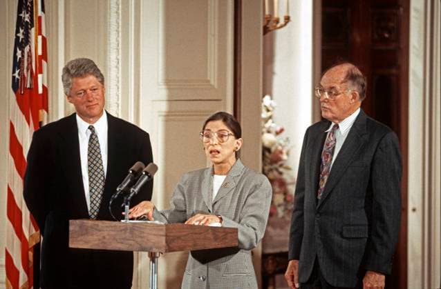 IMAGO ICONS: Ruth Bader Ginsburg August 10, 1993, Washington, District of Columbia, USA: Associate Justice of the Supreme Court Ruth Bader Ginsburg, center, makes remarks prior to taking the oath of office during a swearing-in ceremony in the East Room of the White House in Washington, DC on August 10, 1993. Looking on are United States President Bill Clinton, left, and Chief Justice of the United States William H. Rehnquist, right. Justice Ginsburg replaces Associate Justice Byron R. White Washington USA - ZUMAs152 19930810_zaa_s152_010 Copyright: xArniexSachsx