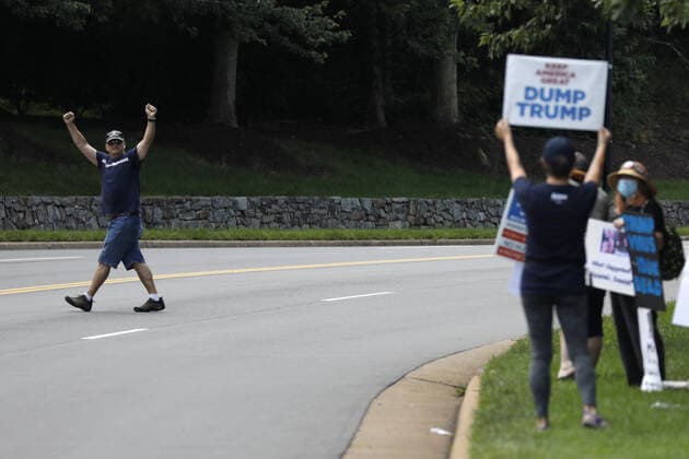 A Trump supporter reacts to protesters outside Trump National Golf Club in Sterling, Virginia while U.S. President Donald Trump plays golf on Sunday, June 21, 2020.  WAX20200621202 YURIxGRIPAS