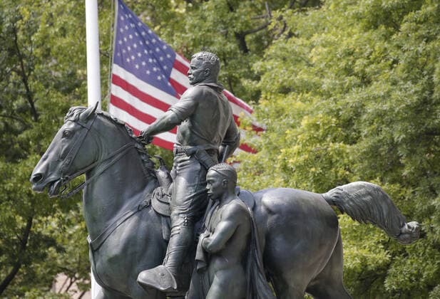 Police barricades surround the area around a bronze statue of former President Theodore Roosevelt at the American Museum Of Natural History in New York City on Monday, June 22, 2020. The statue of the 26th president flanked by walking Native American and African figures was unveiled to the public in front of the museum s Central Park West entrance in 1940. Statues in the United States and around the world have been knocked down, removed and vandalized as a debate swirls over monuments that represent possible racial oppression.  NYP20200622103 JOHNxANGELILLO
