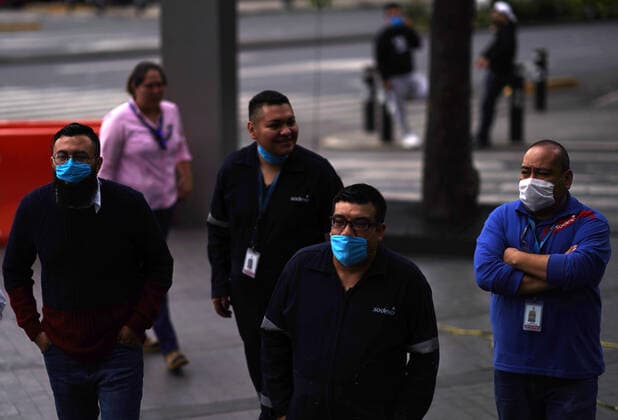 (200623) -- MEXICO CITY, June 23, 2020 -- People with face masks react after an earthquake in Mexico City, capital of Mexico, on June 23, 2020. An earthquake with a magnitude of 7.4 jolted 12 km SSW of Santa Maria Zapotitlan of Mexico at 15:29:05 GMT on Tuesday, the U.S. Geological Survey said. David de la Paz) MEXICO-MEXICO CITY-EARTHQUAKE e DAVIDxDExLAxPAZ 